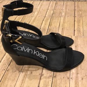 Calvin Klein black and gold block heeled sandal.